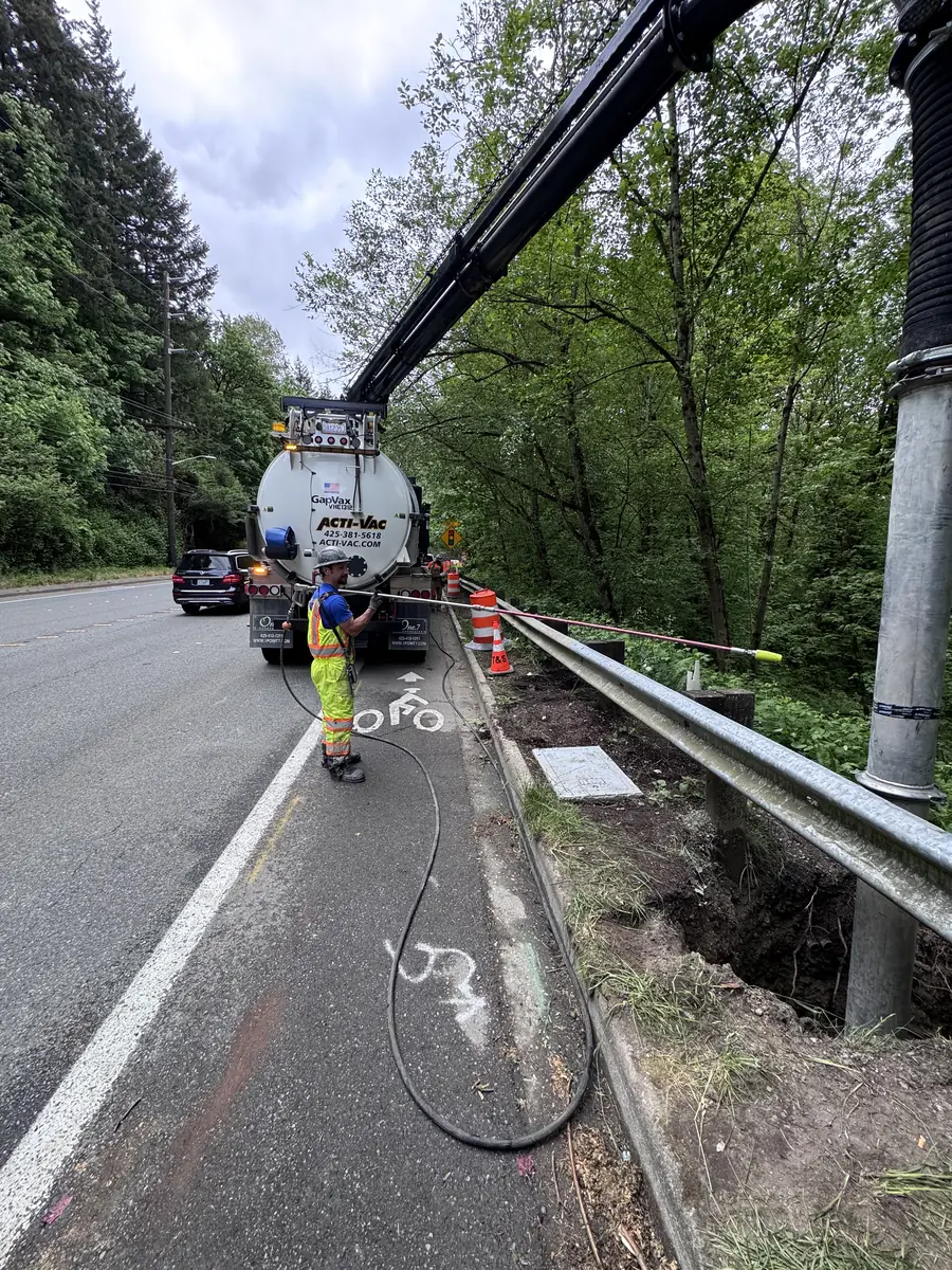 Roadside potholing behind the guardrail on a wooded highway