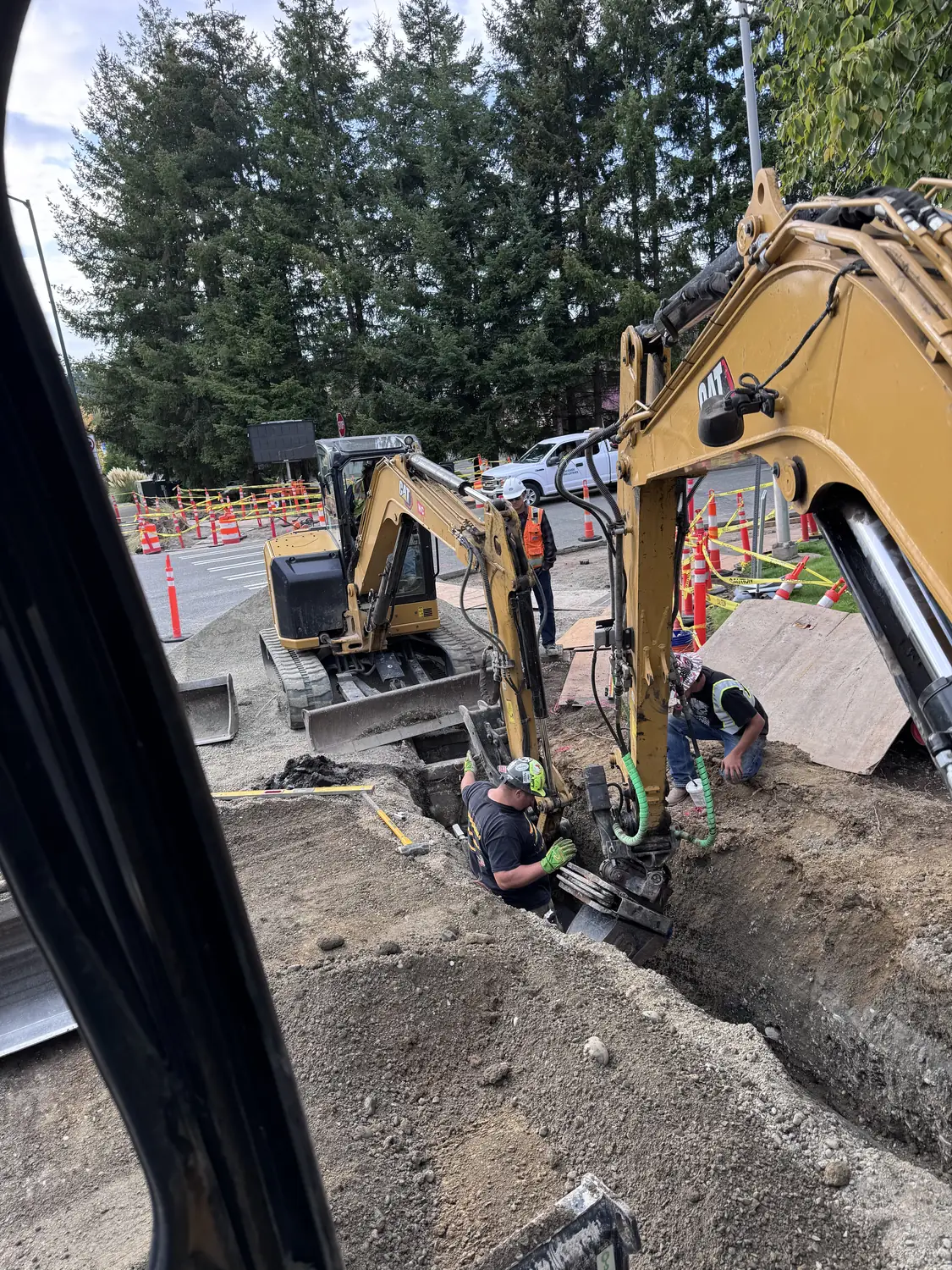 Always Active crew and excavators working a roadside sewer and utility trench
