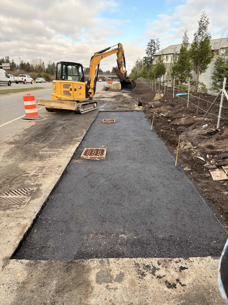 New sidewalk and storm-drain work along a county road