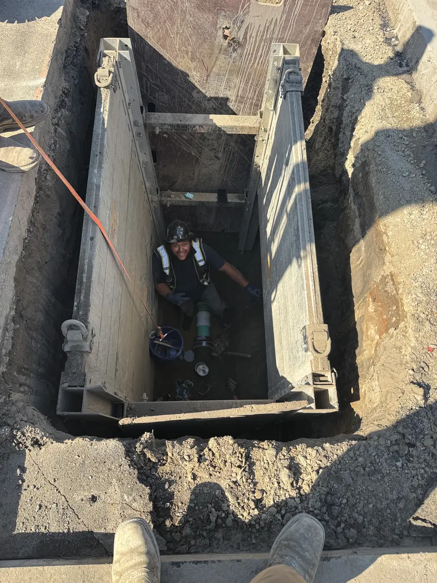 Utility pipe work in a shored trench